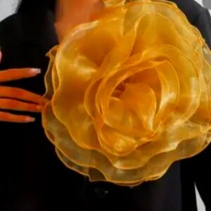 Gold flower that goes great with black or white dress.
